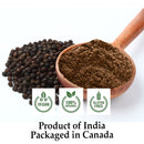 Organic Black Pepper Powder in a rounded wooden scoop alongside a pile of whole black peppercorns, authenticated as vegan, 100% organic, and gluten-free-harvested in India, packaged in Canada.