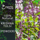 Organic Mantra 100% natural Krishna Tulsi Holy Basil Powder product image featuring a lush live tulsi plant in full bloom with tall deep-purple stems, white flower clusters, and bright green leaves.