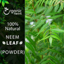 Organic Mantra 100% natural Neem Leaf Powder product image featuring a lush close-up of a live neem tree branch with characteristically serrated pinnate green leaves in natural light.