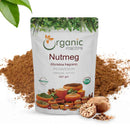 Organic Mantra Nutmeg Myristica fragrans Powder 227g standup pouch with USDA Organic and OneCert certifications, origin India, displayed over a mound of brown nutmeg powder with a halved and whole nutmeg seed beside it.
