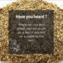 Shatavari cut and sifted fact card with a dark semi-transparent overlay on a macro close-up of coarse dry Asparagus racemosus root shreds in mixed tan and olive-grey tones, featuring white botanical line art and text noting its dual use as a brewed herbal tea and topical skin paste.