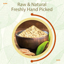 Raw and natural, freshly hand-picked Shatavari cut and sifted root pieces are heaped in a dark rustic wooden bowl with whole dried Asparagus racemosus finger roots and a fresh green leaf beside it, framed inside a warm yellow double circle with a rust-orange decorative arc over a cream leaf-vein texture background.