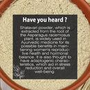 Shatavari Powder fact card with a dark semi-transparent overlay on a macro close-up of pale beige Asparagus racemosus root powder inside a terracotta bowl, featuring white botanical line art and text noting its Ayurvedic root origin, women's reproductive health and hormonal balance benefits, and adaptogenic stress-reducing properties.