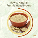 Raw and natural, freshly hand-picked Shatavari powder is heaped in a terracotta clay bowl alongside dry Asparagus racemosus root sticks and a wooden spoon holding pale beige powder, framed inside a warm yellow double circle with a rust-orange decorative arc over a cream leaf-vein-texture background.
