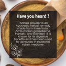 Triphala Powder informational card explaining its three-fruit Ayurvedic composition of Amla, Haritaki, and Bibhitaki, and its centuries-long use for digestive wellness in traditional Indian medicine.
